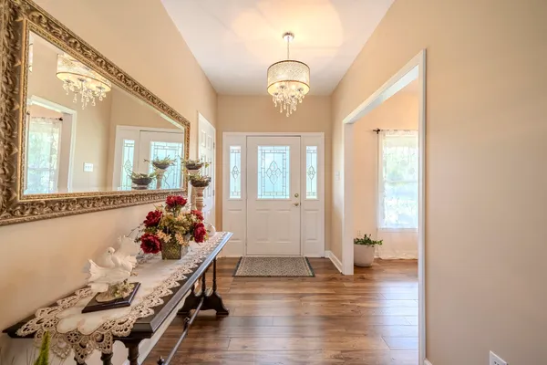 a view of a kids room with wooden floor and windows