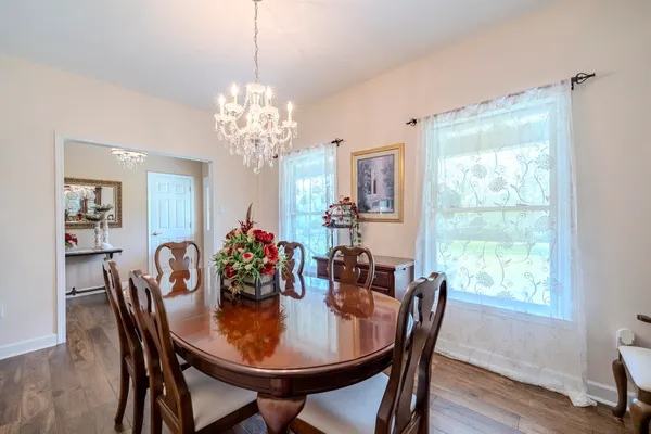 a view of a dining room with furniture window and wooden floor