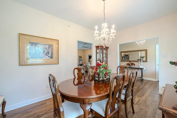 a view of a dining room with furniture and chandelier