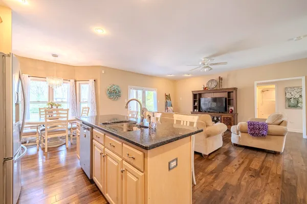 a very nice looking living room with a large window and a wooden floor