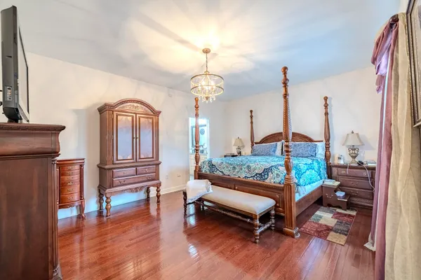 a sitting area with furniture and a wooden floor