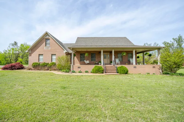 a front view of house with yard and green space