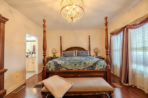 a bedroom with a bed and a mirror