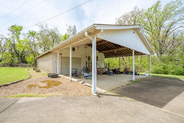 a view of a house with backyard and sitting area