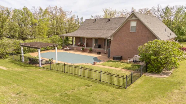 a view of a house with backyard and sitting area