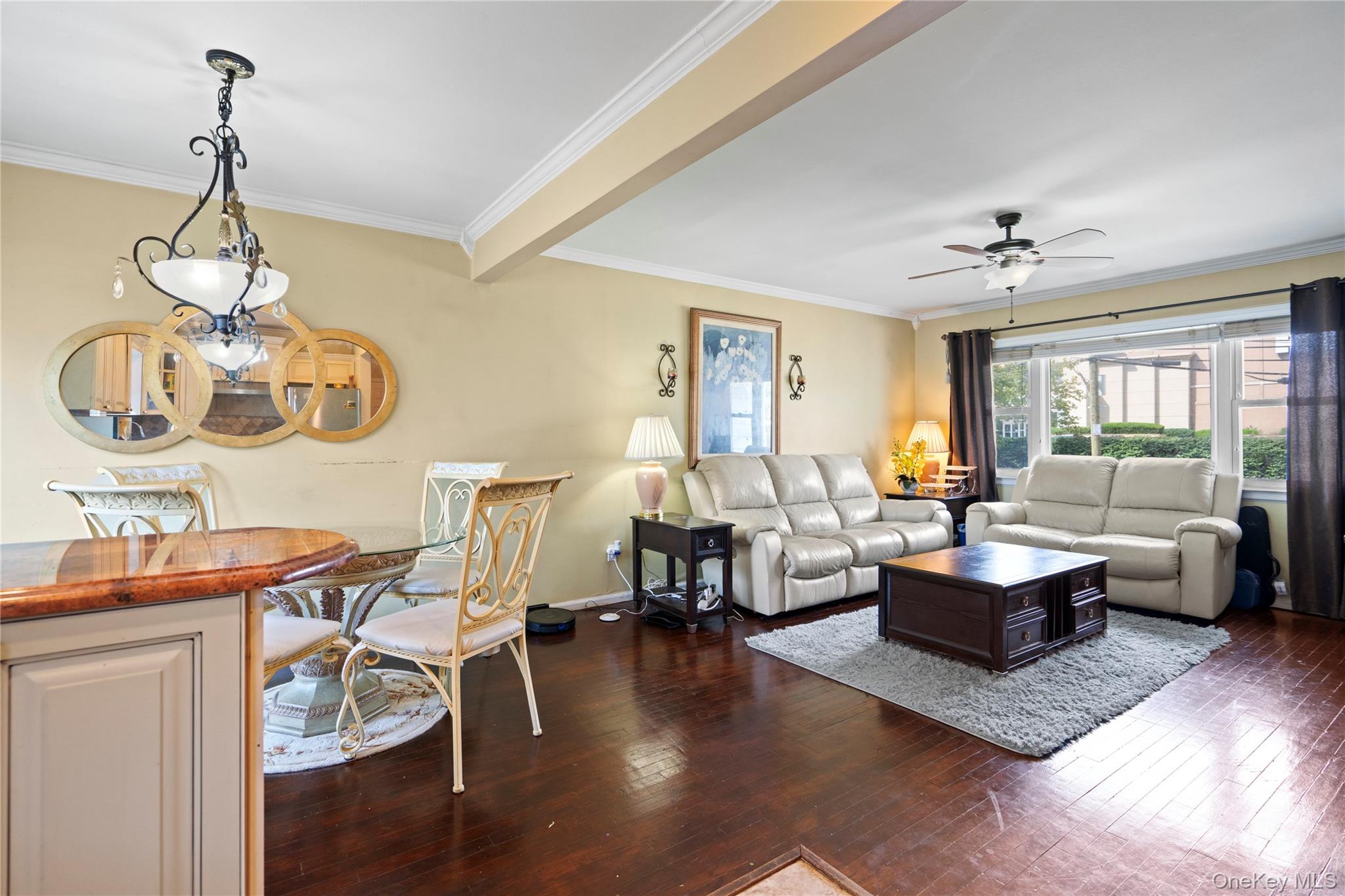 304 Unqua Road Massapequa, NY 11758 - Photo 11 of 26 a living room with fireplace furniture and a wooden floor
