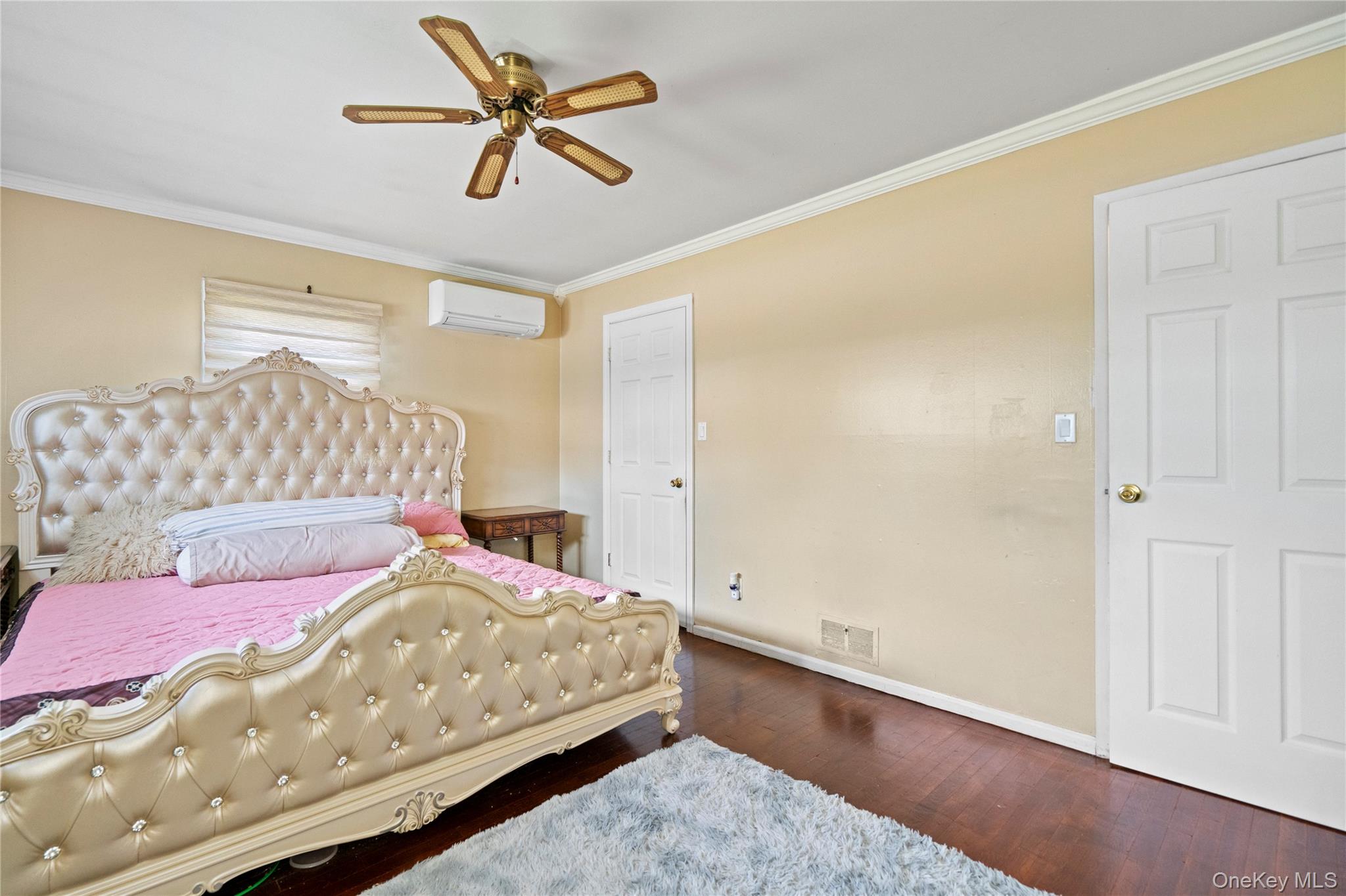 304 Unqua Road Massapequa, NY 11758 - Photo 13 of 26 a bedroom with a bed and a chandelier
