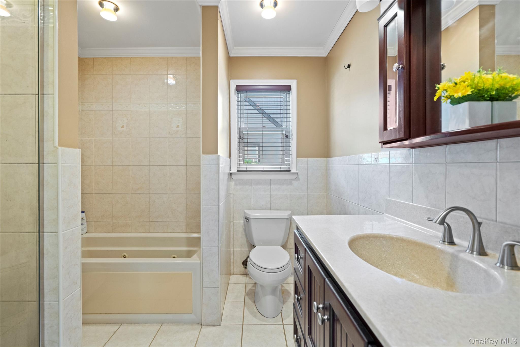 304 Unqua Road Massapequa, NY 11758 - Photo 15 of 26 a bathroom with a granite countertop sink toilet and shower