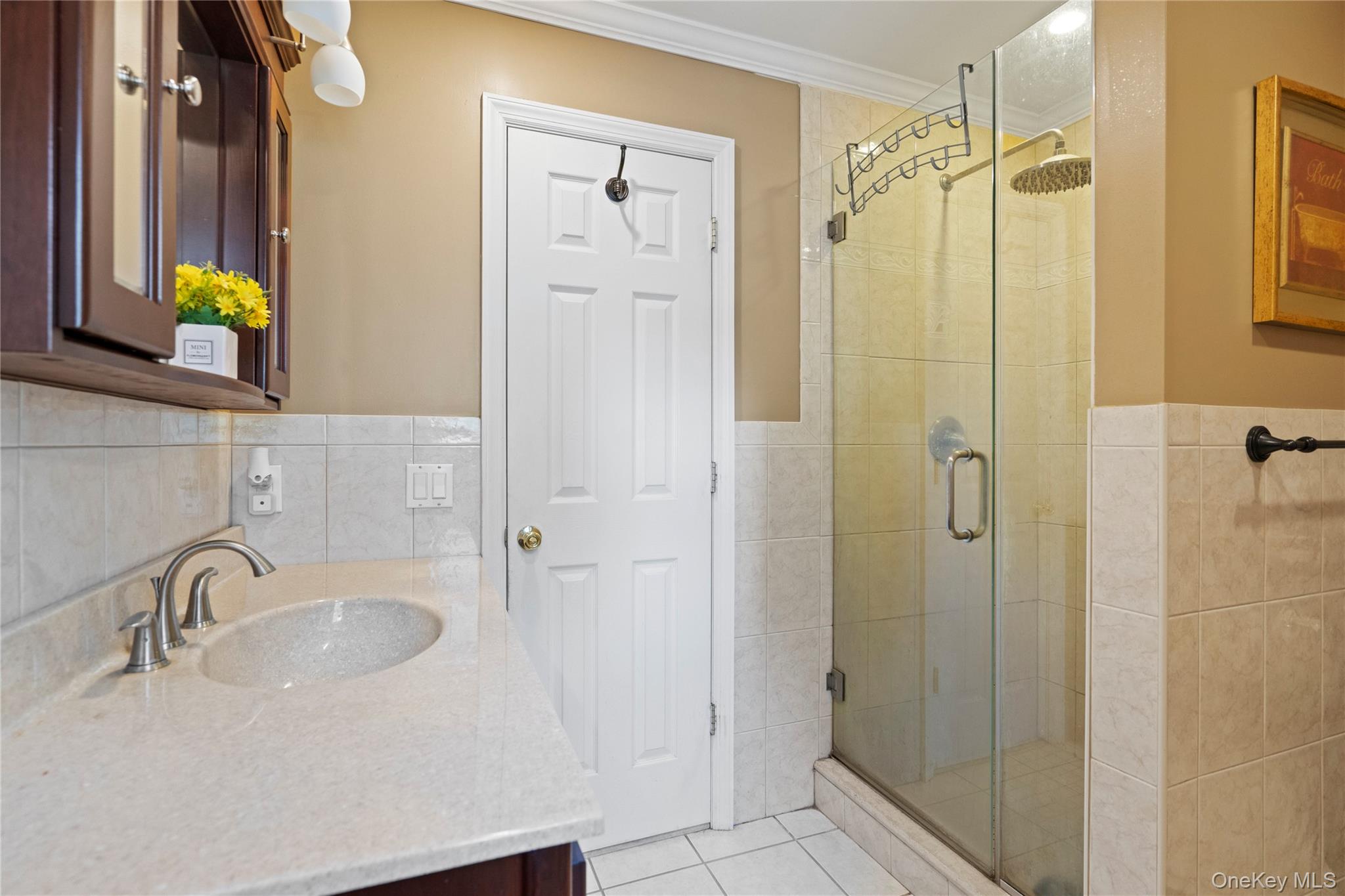 304 Unqua Road Massapequa, NY 11758 - Photo 16 of 26 a bathroom with a sink and a shower