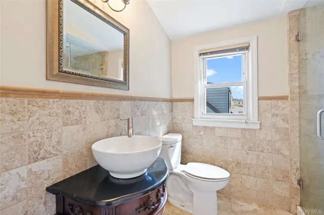 a bathroom with a toilet sink and mirror