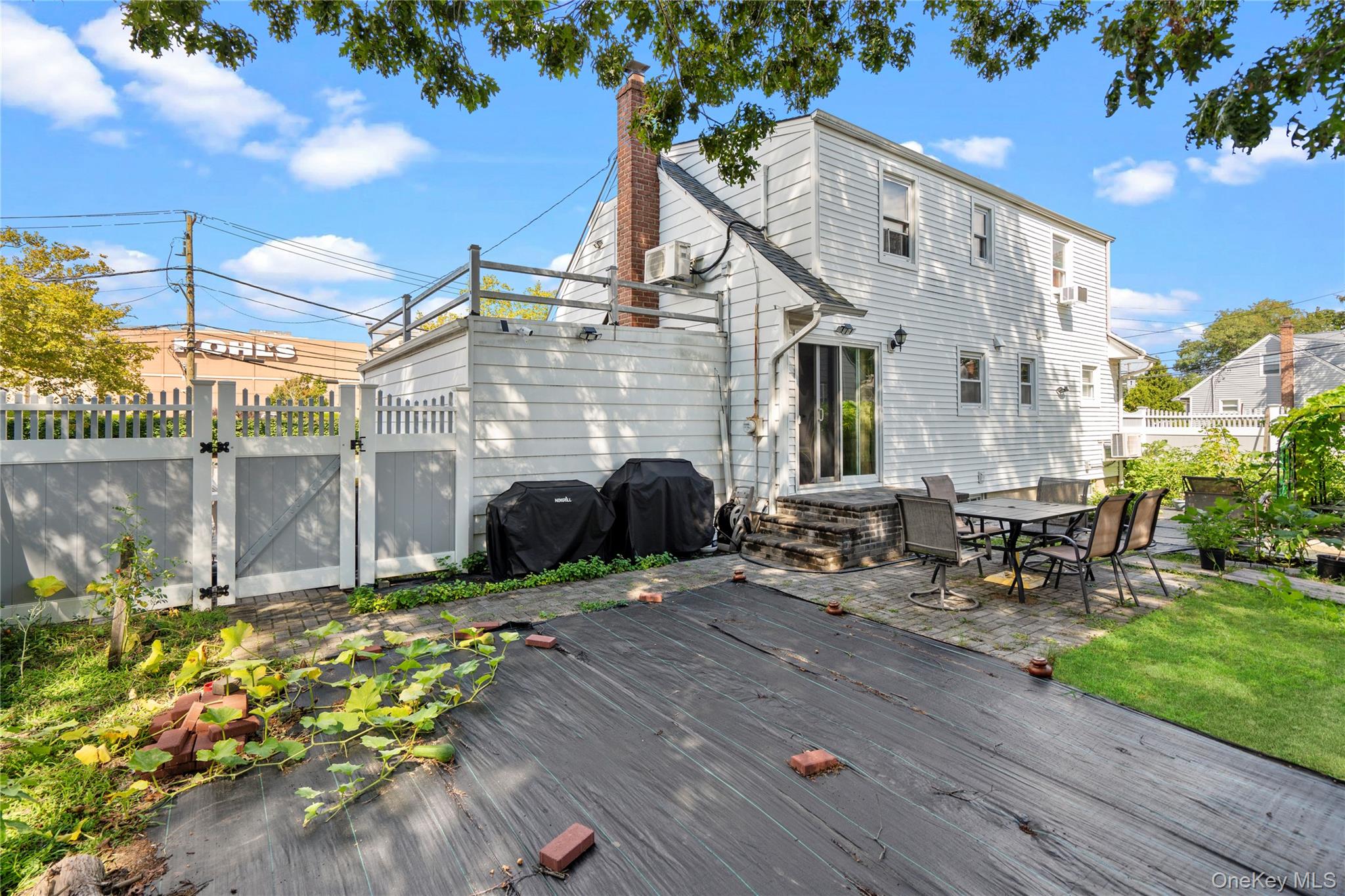 304 Unqua Road Massapequa, NY 11758 - Photo 23 of 26 a view of a chair and table in the patio with a garden
