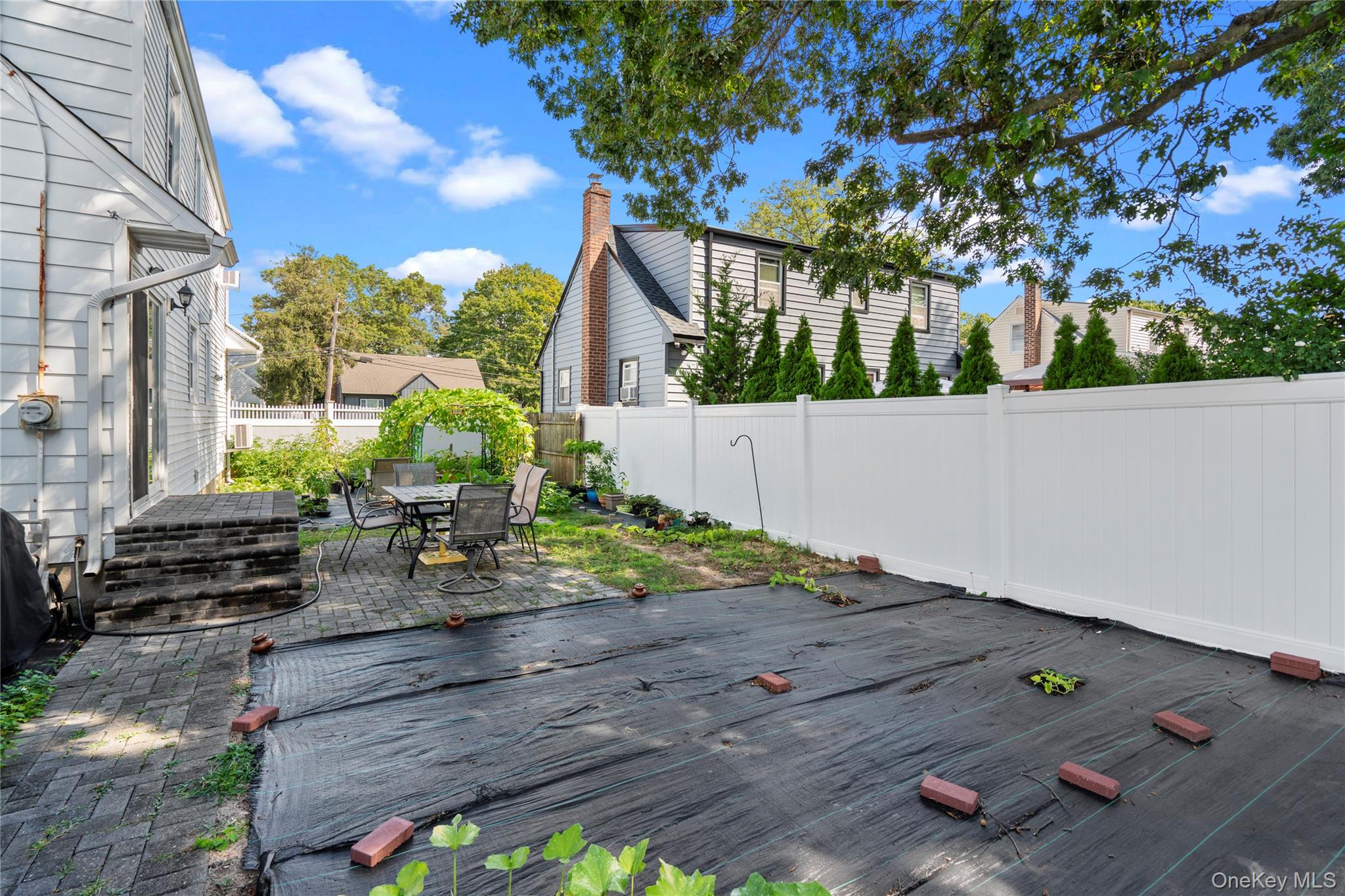 304 Unqua Road Massapequa, NY 11758 - Photo 24 of 26 a view of backyard with wooden fence