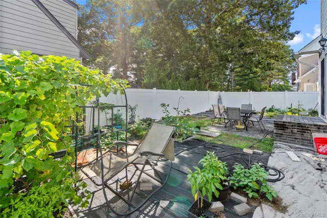 a view of a patio with table and chairs and potted plants