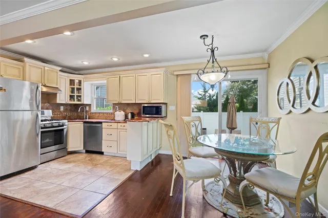 a kitchen with refrigerator cabinets dining table and chairs