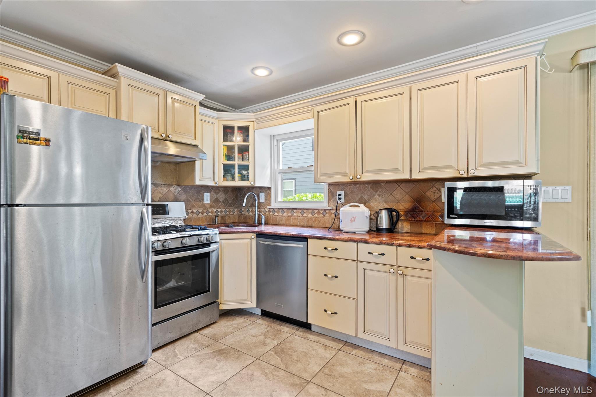 304 Unqua Road Massapequa, NY 11758 - Photo 9 of 26 a kitchen with stainless steel appliances granite countertop a refrigerator sink and stove