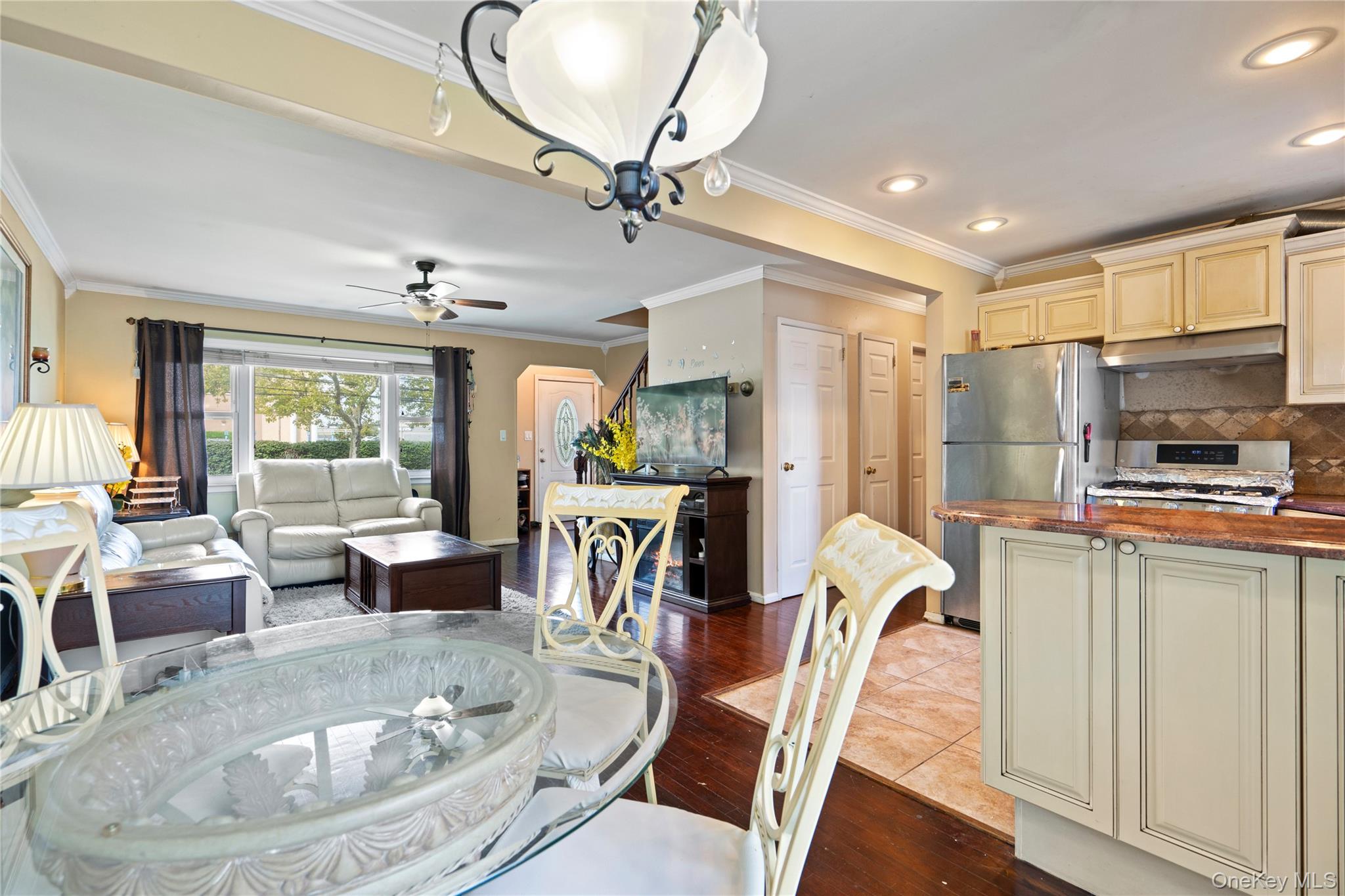 304 Unqua Road Massapequa, NY 11758 - Photo 10 of 26 a dining room with furniture a chandelier and window
