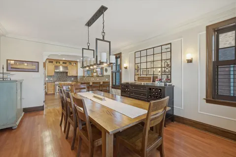 a kitchen with granite countertop a sink and white cabinets