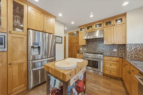 a bedroom with a large bed and wooden floor