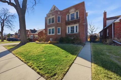 a view of a brick building next to a yard