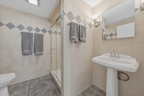 a kitchen with stainless steel appliances kitchen island granite countertop a table chairs and a refrigerator