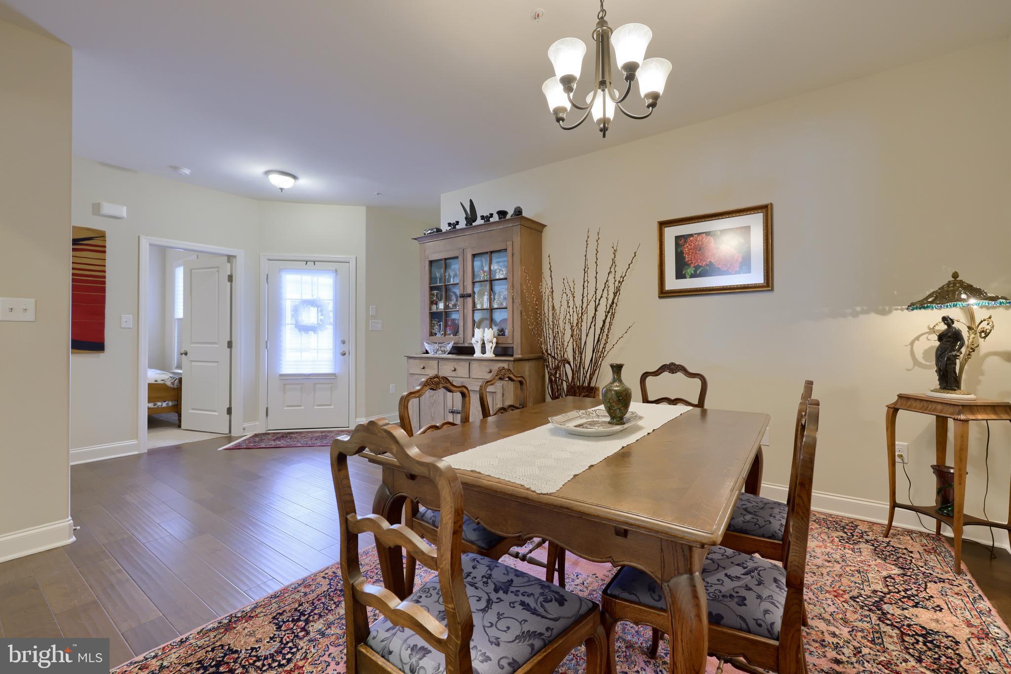 364 Pin Oak Drive Lititz, PA 17543 - Photo 10 of 39 a view of a dining room with furniture wooden floor and a chandelier