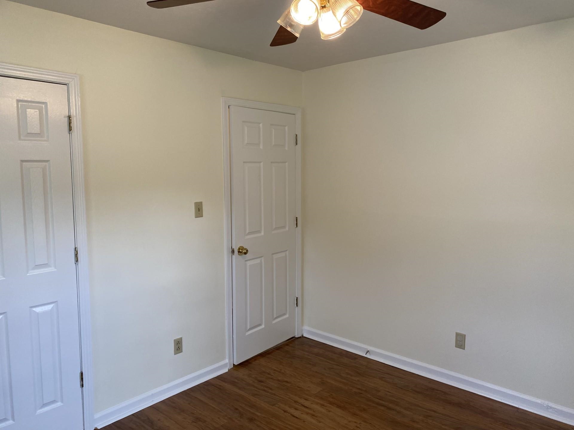 81 Candlewick Drive Jackson, TN 38305 - Photo 21 of 30 a view of an empty room with wooden floor and a chandelier fan