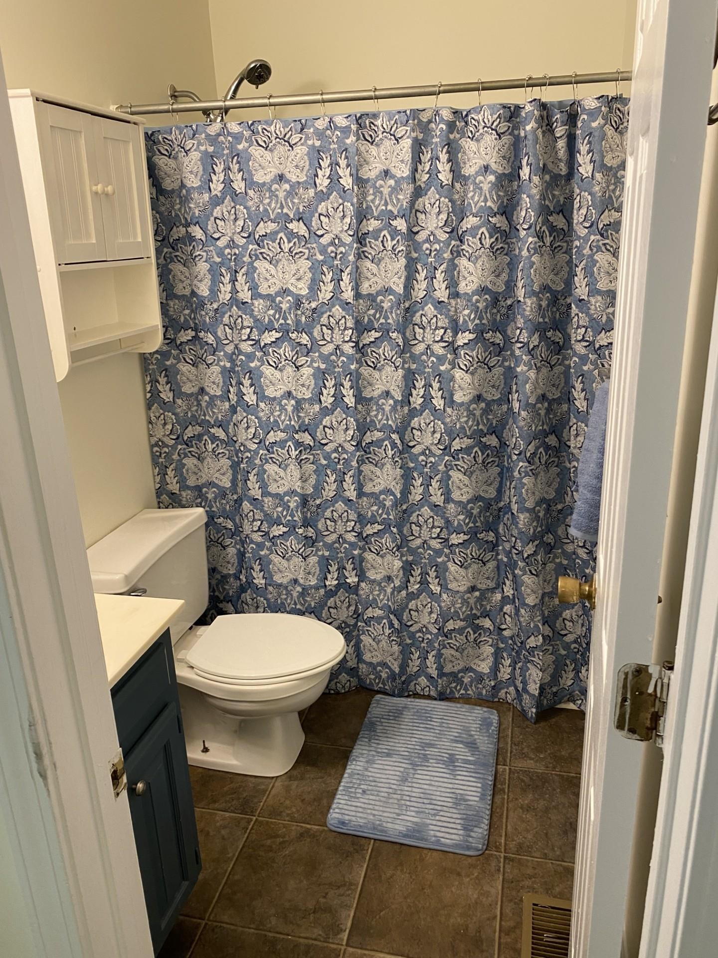 81 Candlewick Drive Jackson, TN 38305 - Photo 28 of 30 a white toilet sitting next to a shower curtain