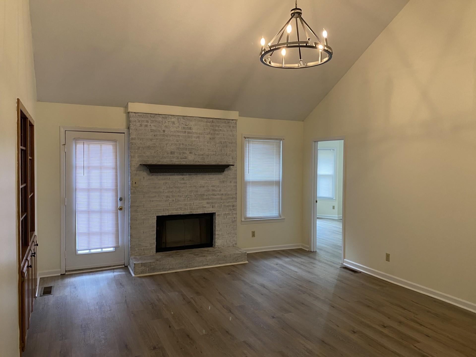 81 Candlewick Drive Jackson, TN 38305 - Photo 9 of 30 an empty room with wooden floor fireplace and window