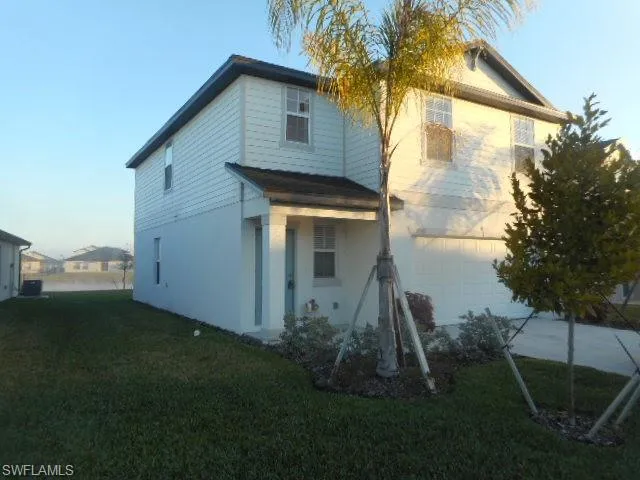 a backyard of a house with table and chairs