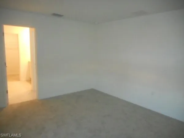 a view of an empty room and a window