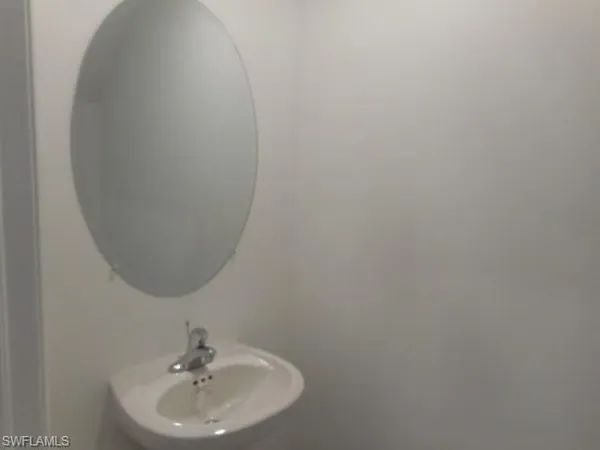 a bathroom with a sink and mirror
