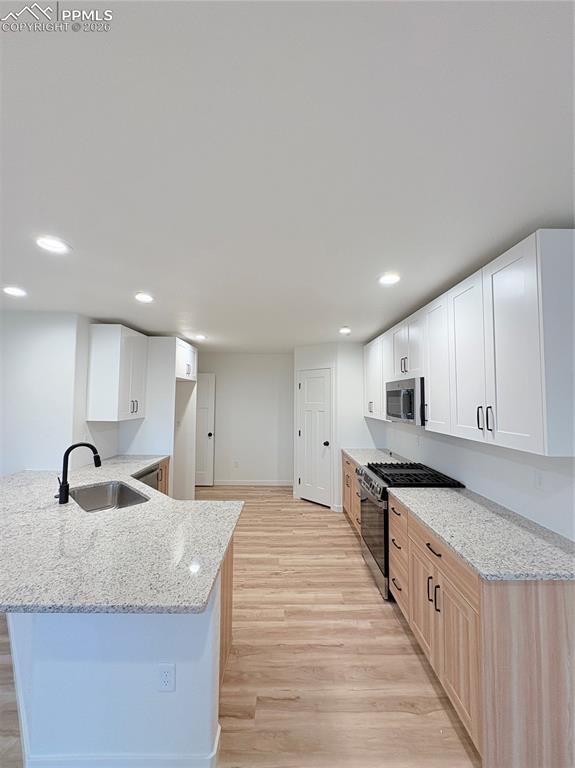 834 Keystone Loop Canon City, CO 81212 - Photo 2 of 14 a large kitchen with stainless steel appliances granite countertop a sink and a stove