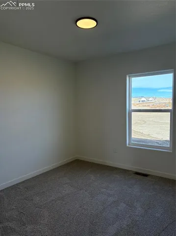 an empty room with closet area