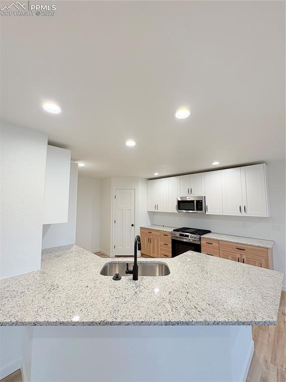834 Keystone Loop Canon City, CO 81212 - Photo 3 of 14 a kitchen with stainless steel appliances granite countertop a sink a stove and a refrigerator