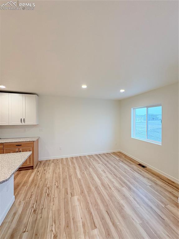 834 Keystone Loop Canon City, CO 81212 - Photo 5 of 14 wooden floor in an empty room with a window