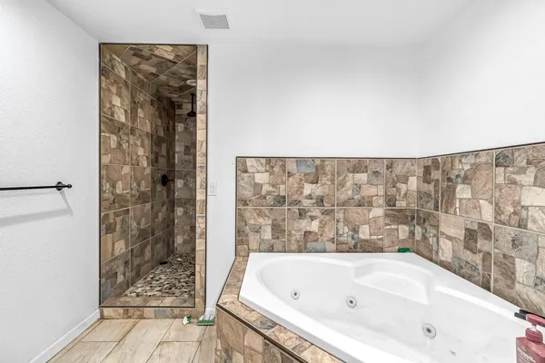 a bathroom with a bathtub and shower
