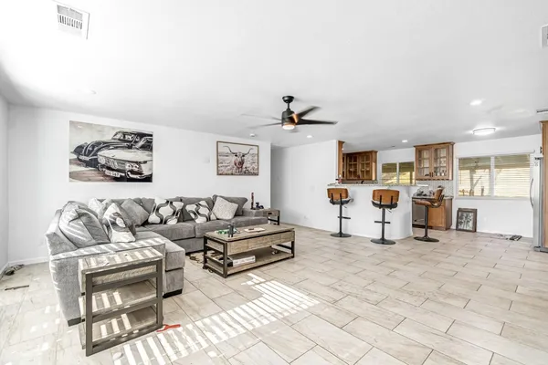 a living room with furniture and kitchen view