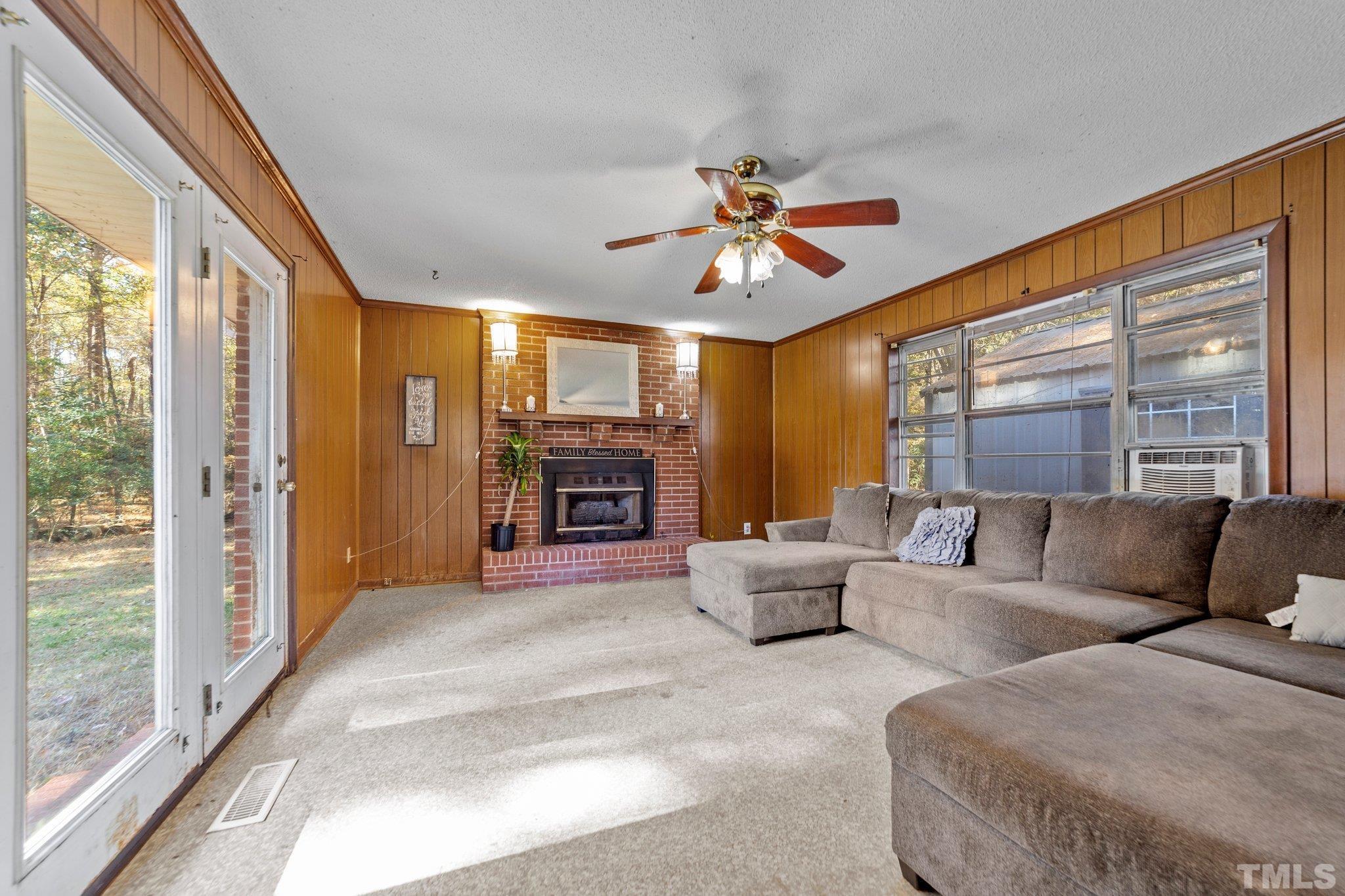 801 Avalon Road Durham, NC 27704 - Photo 17 of 30 a living room with furniture a fireplace and a large window