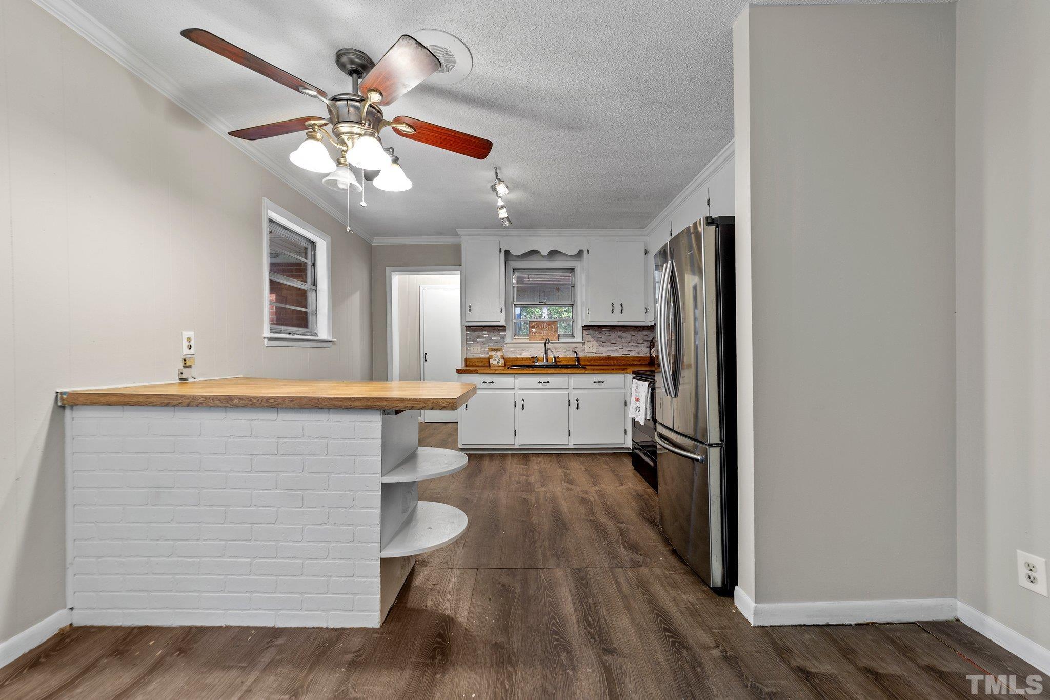 801 Avalon Road Durham, NC 27704 - Photo 21 of 30 a view of a kitchen with wooden floor and a ceiling fan