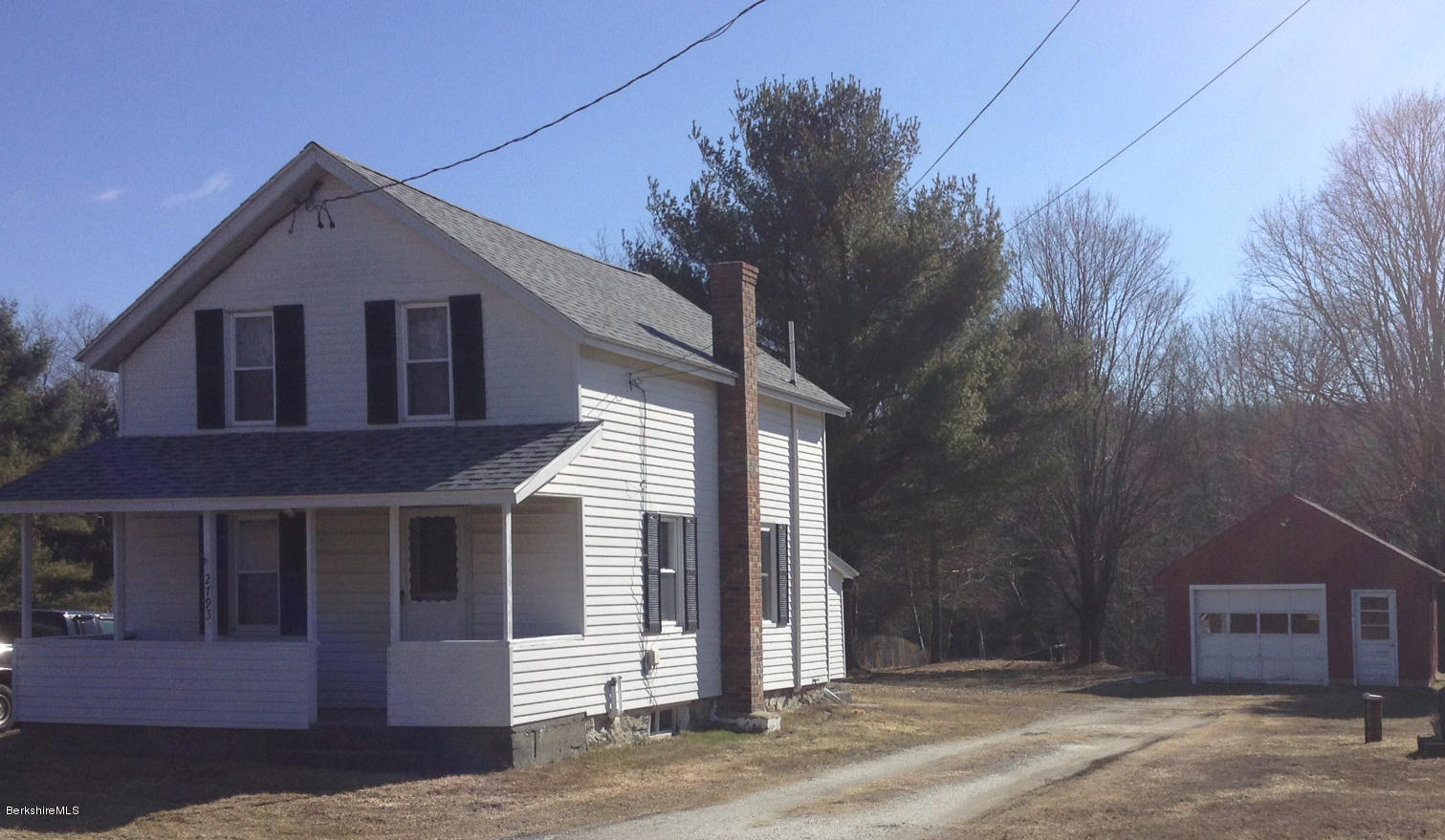 a front view of a house with a tree