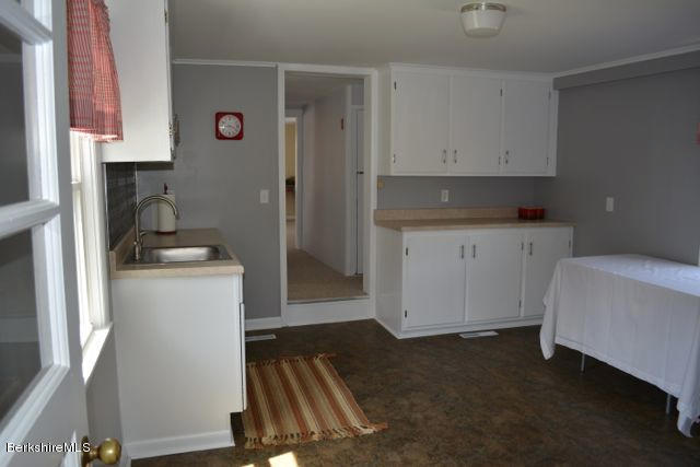2793 State Road Richmond, MA 01254 - Photo 3 of 20 a kitchen with a refrigerator and white cabinets