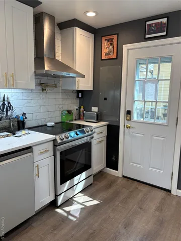 a kitchen with stainless steel appliances a stove a sink and a microwave