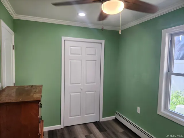 a room with wooden floors and a window