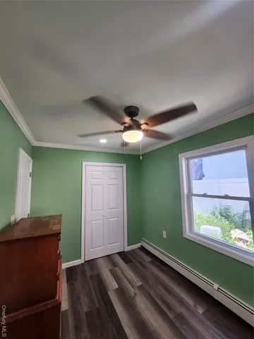 a view of room with window and wooden floor