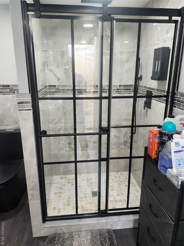 a view of an empty room and wooden floor