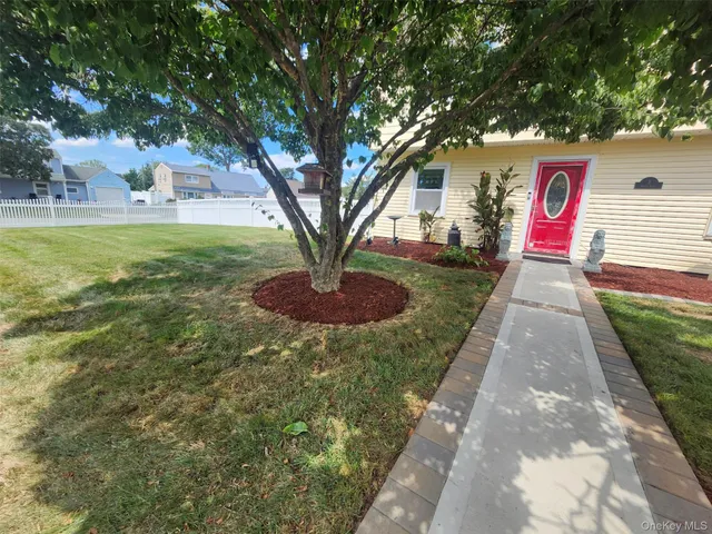 a sign board with yard in the back