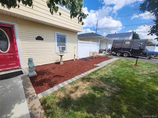 a backyard of a house with yard and outdoor seating