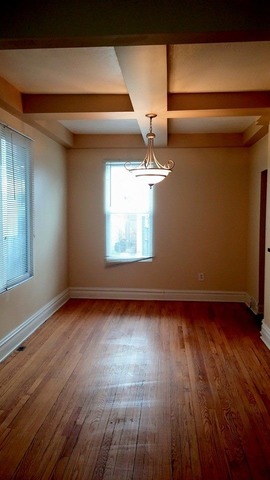 3531 West 65th Street Chicago, IL 60629 - Photo 6 of 25 a view of an empty room with wooden floor and a window
