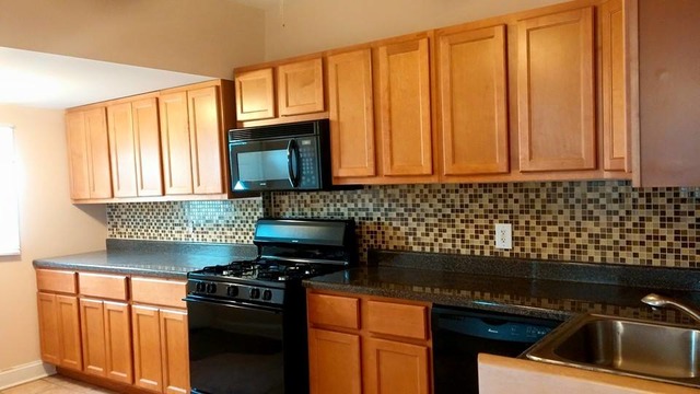3531 West 65th Street Chicago, IL 60629 - Photo 9 of 25 a kitchen with granite countertop a stove sink and cabinets