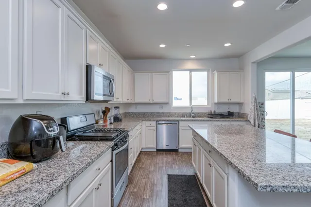 a kitchen with a sink stove and cabinets